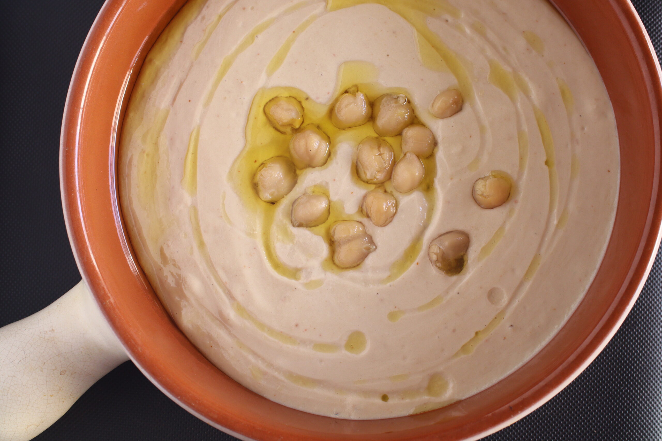 Middle Eastern dip Hummus topped with olive oil & chickpeas