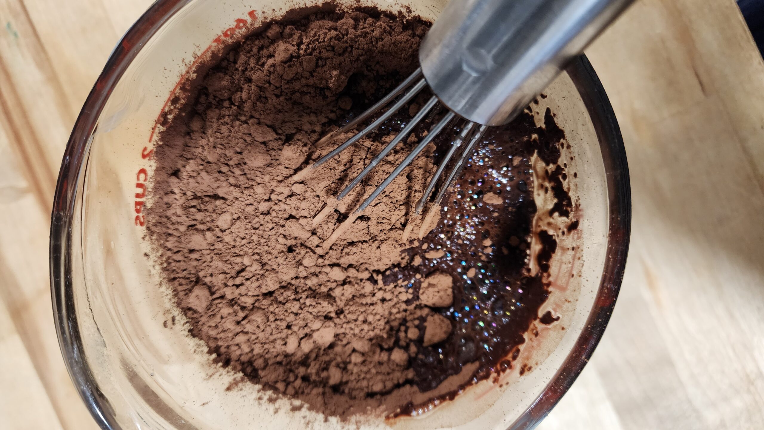 Cocoa powder being mixed with hot water